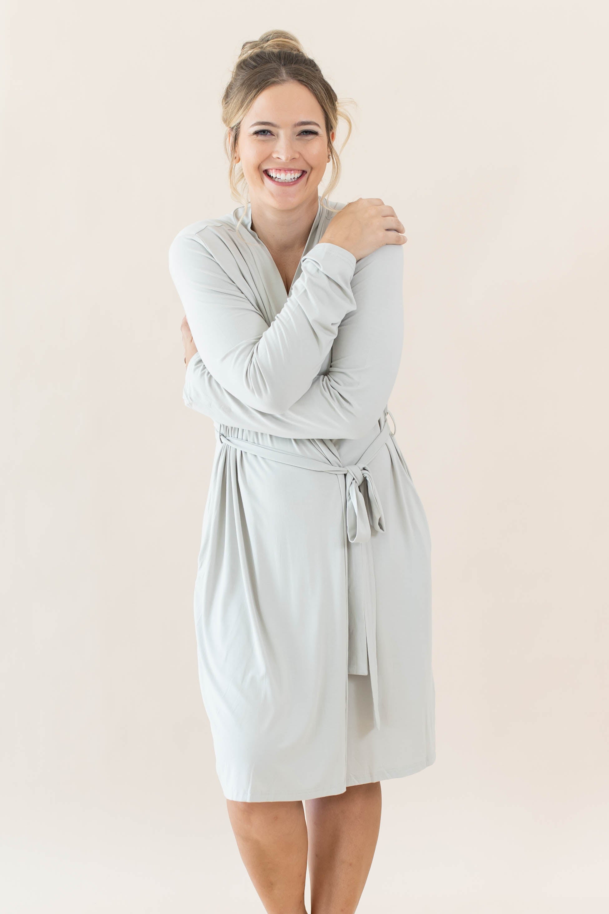 Female hugging herself wearing the Women’s Lounge Robe in Oat