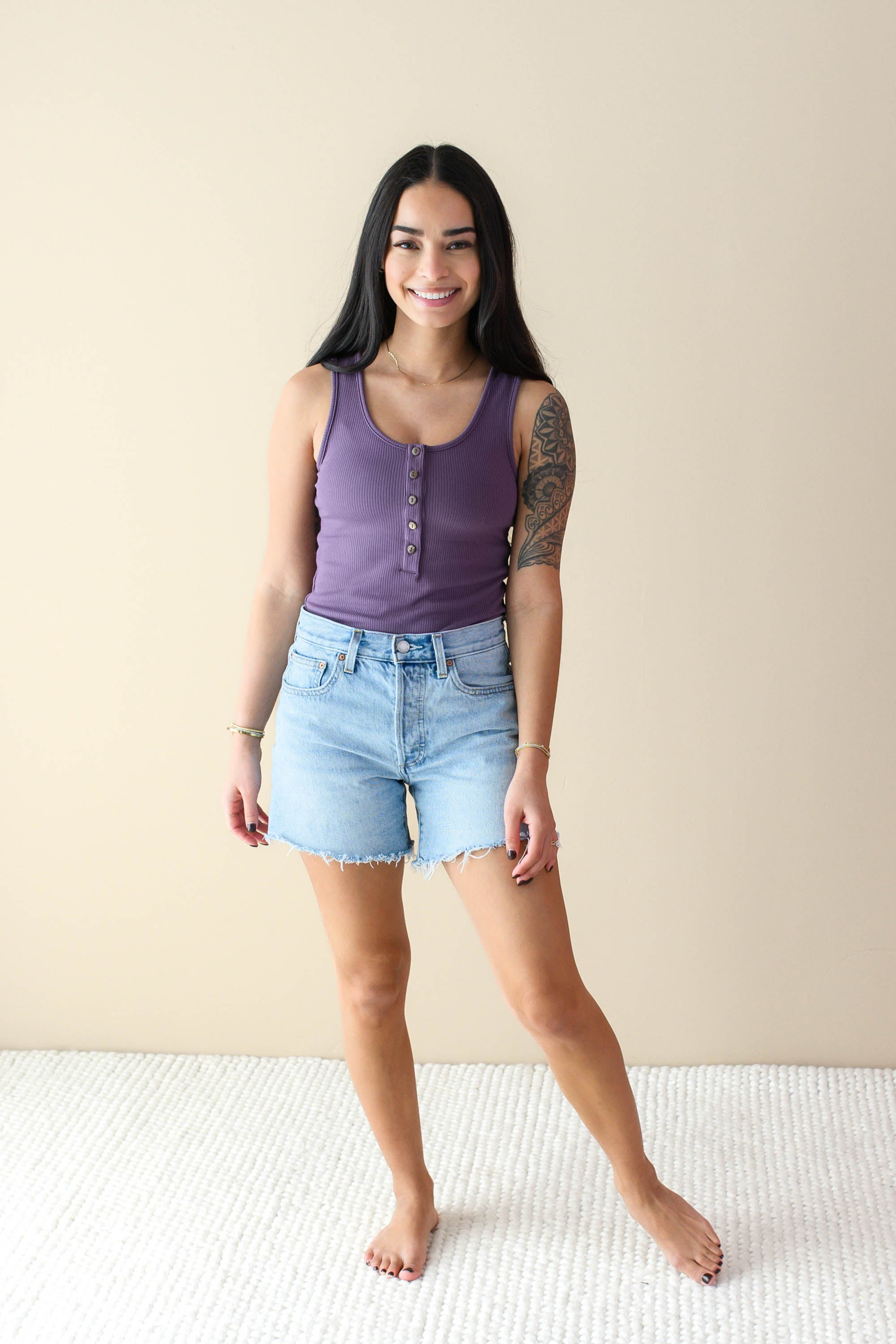 Female model wearing the Women’s Ribbed Henley Bodysuit in Currant