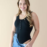 Female displaying the bodysuit cut of the Women’s Ribbed Henley Bodysuit in Midnight