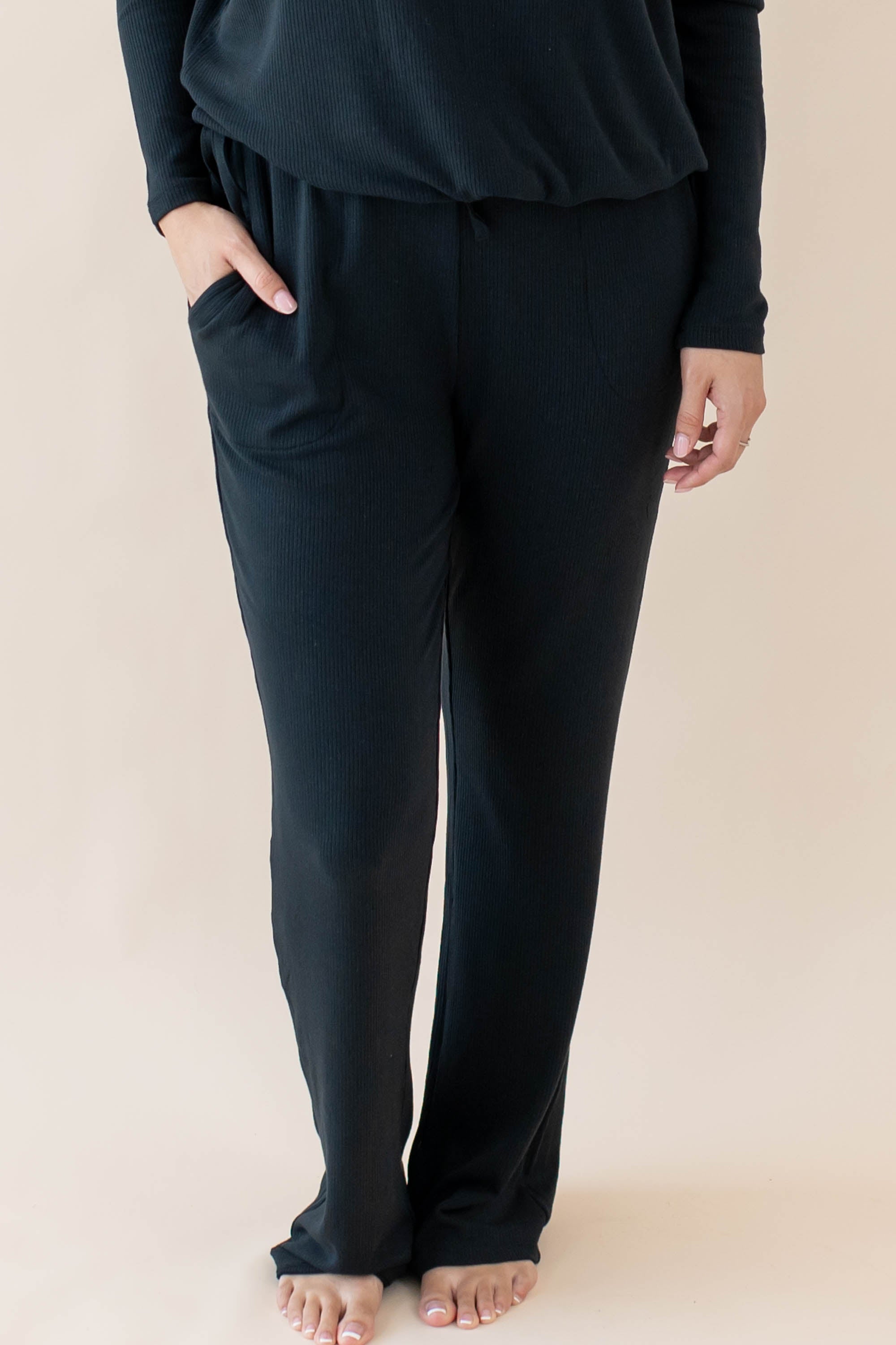 Female wearing the Women's Ribbed High Waisted Wide Leg Pant in Midnight with one hand in pants pocket