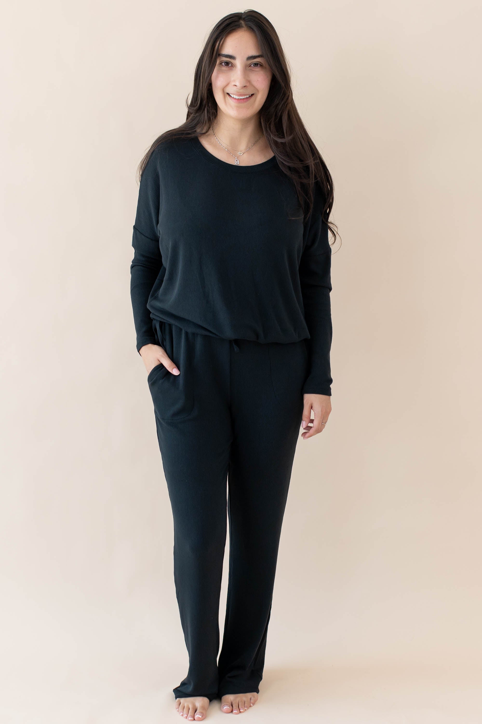 Model wearing the Women's Ribbed High Waisted Wide Leg Pant in Midnight with one hand in pants pocket