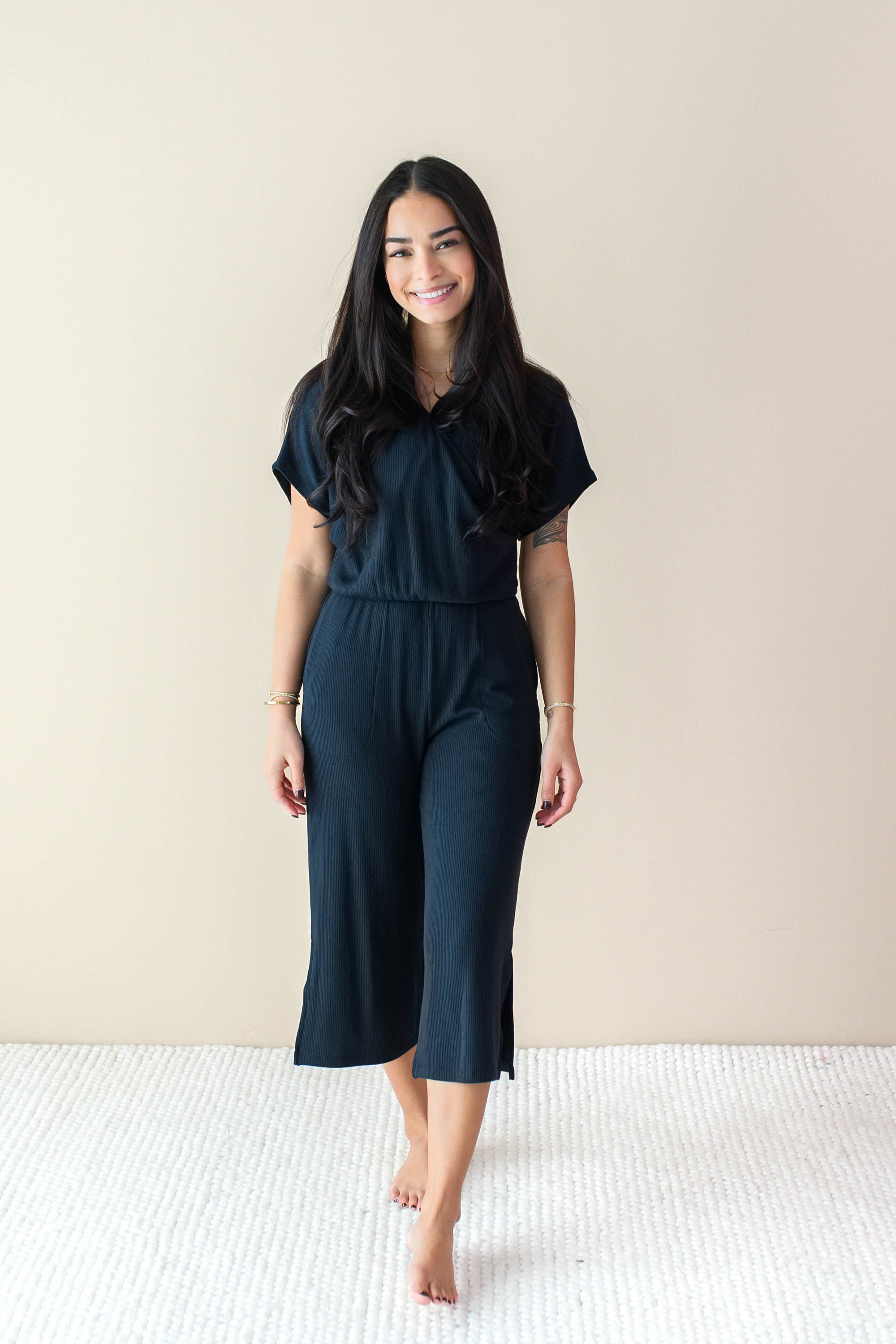 Model wearing the Women's Ribbed Jumpsuit in Midnight