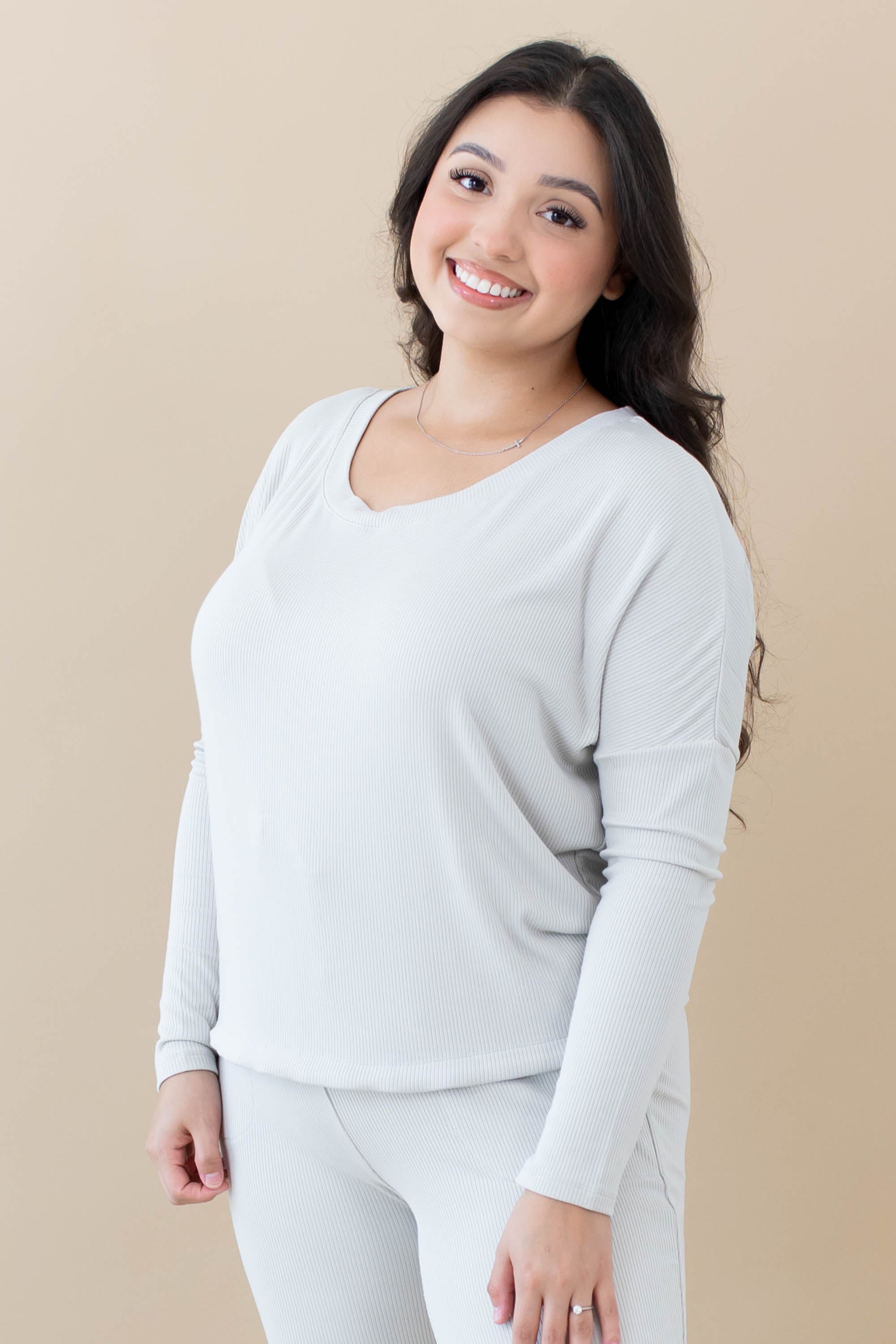 Female modeling the Women's Ribbed Long Sleeve Drop Shoulder Top in Oat paired with Oat Jogger Pants