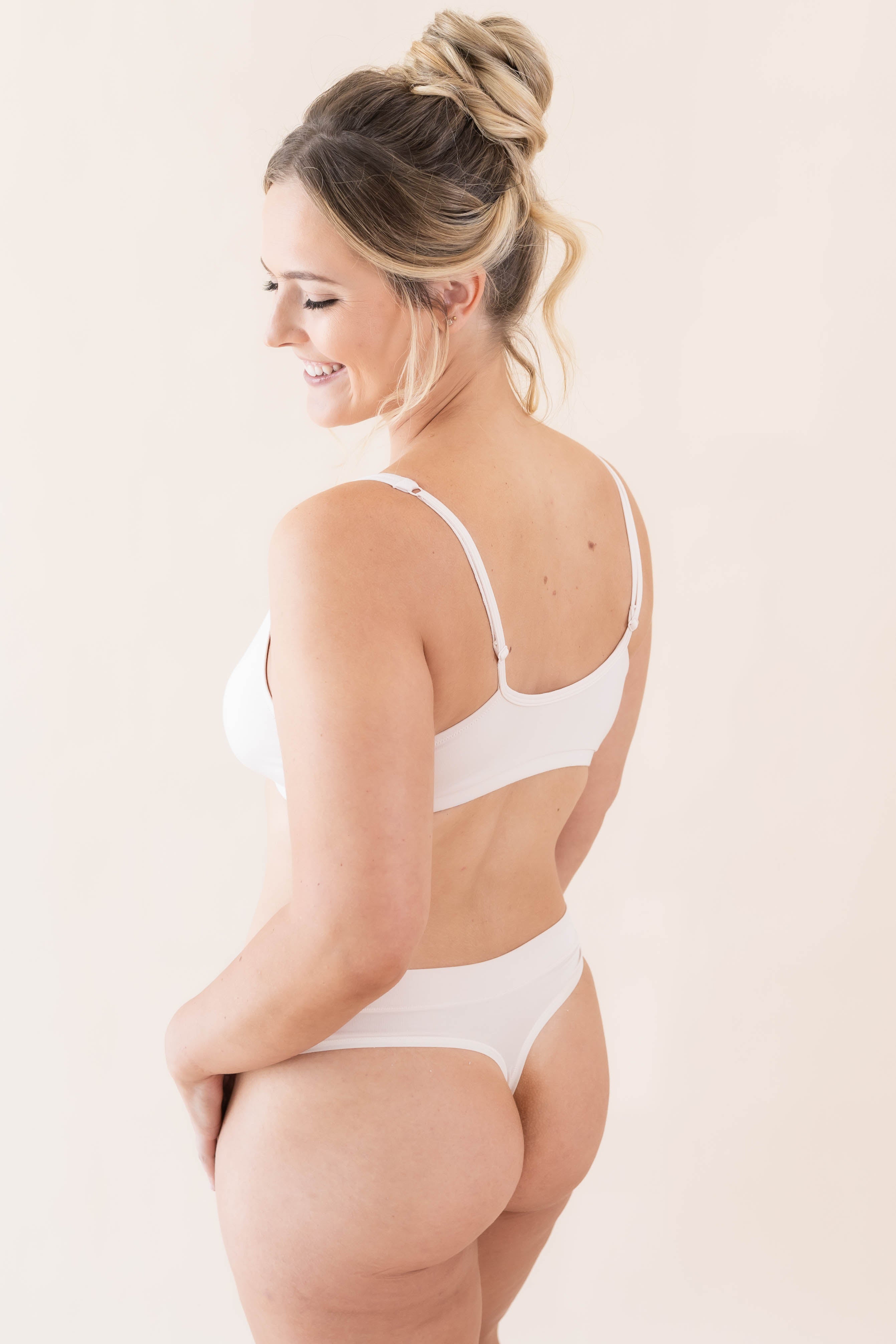 Side view of model wearing Kyte Baby's Women's Thong in Blonde