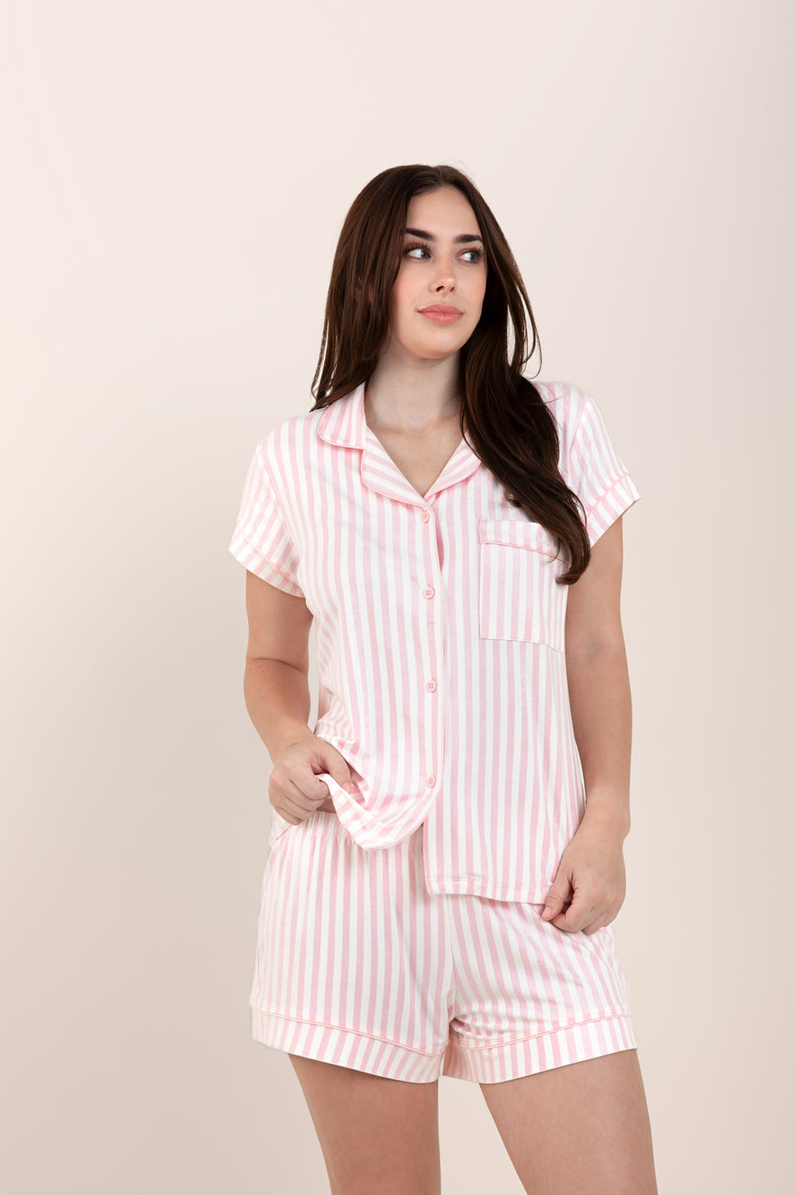 Woman looking to the side while modeling the Bamboo Women's Short Sleeve Pajama Set in Small Sakura Stripe