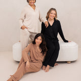 Three female models wearing the Long-Sleeved Women's Pajama Set in Latte with Latte Trim, Midnight with Midnight Trim and Bisque with Bisque Trim