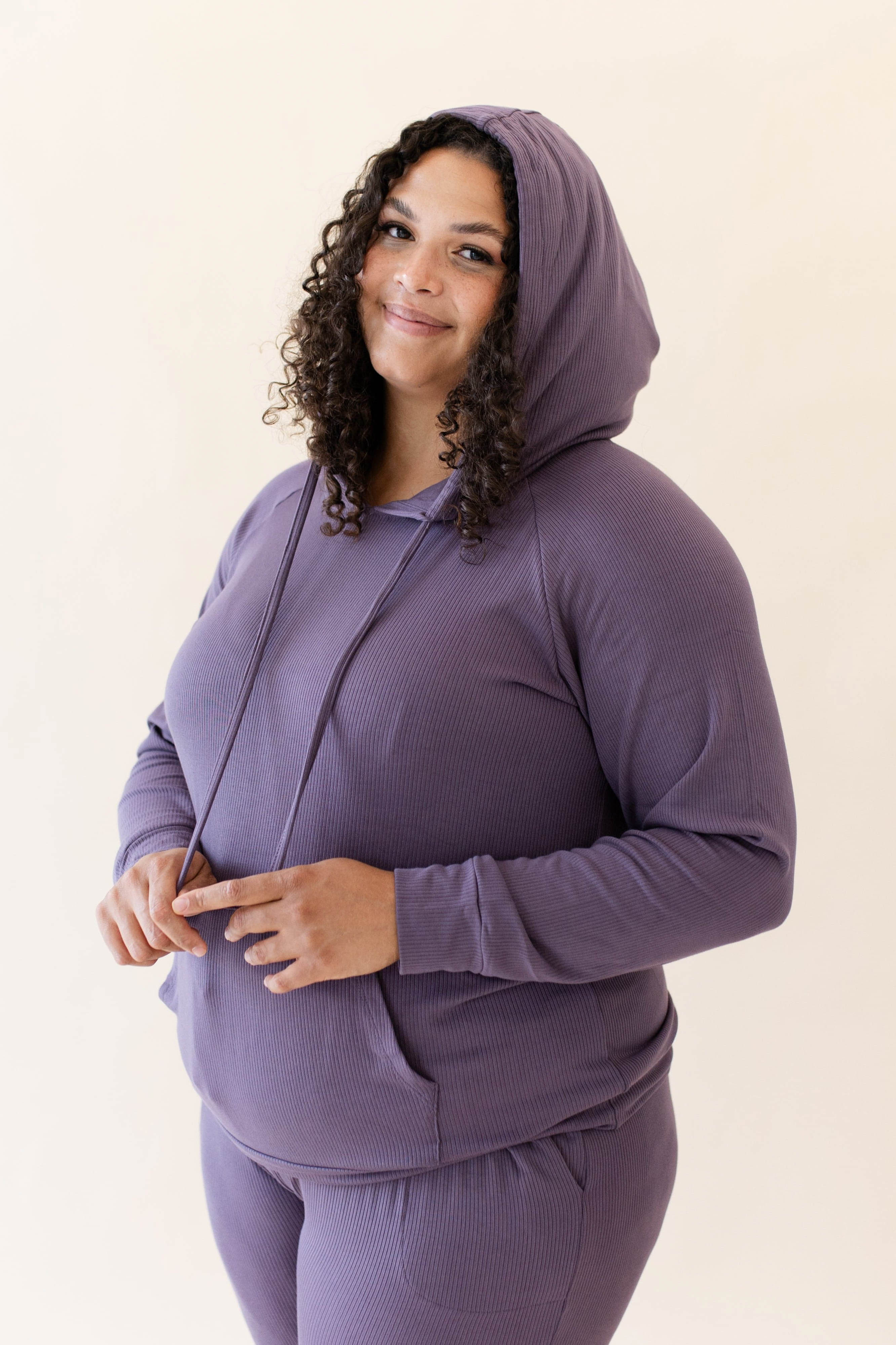 Model wearing the Women's Ribbed Hoodie in Currant paired with Currant Jogger Pants