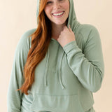 Model wearing the Women's Ribbed Hoodie in Thyme paired with Thyme Jogger Pants