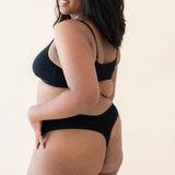 The back of the Kyte Baby's Women's Thong in Midnight on a model