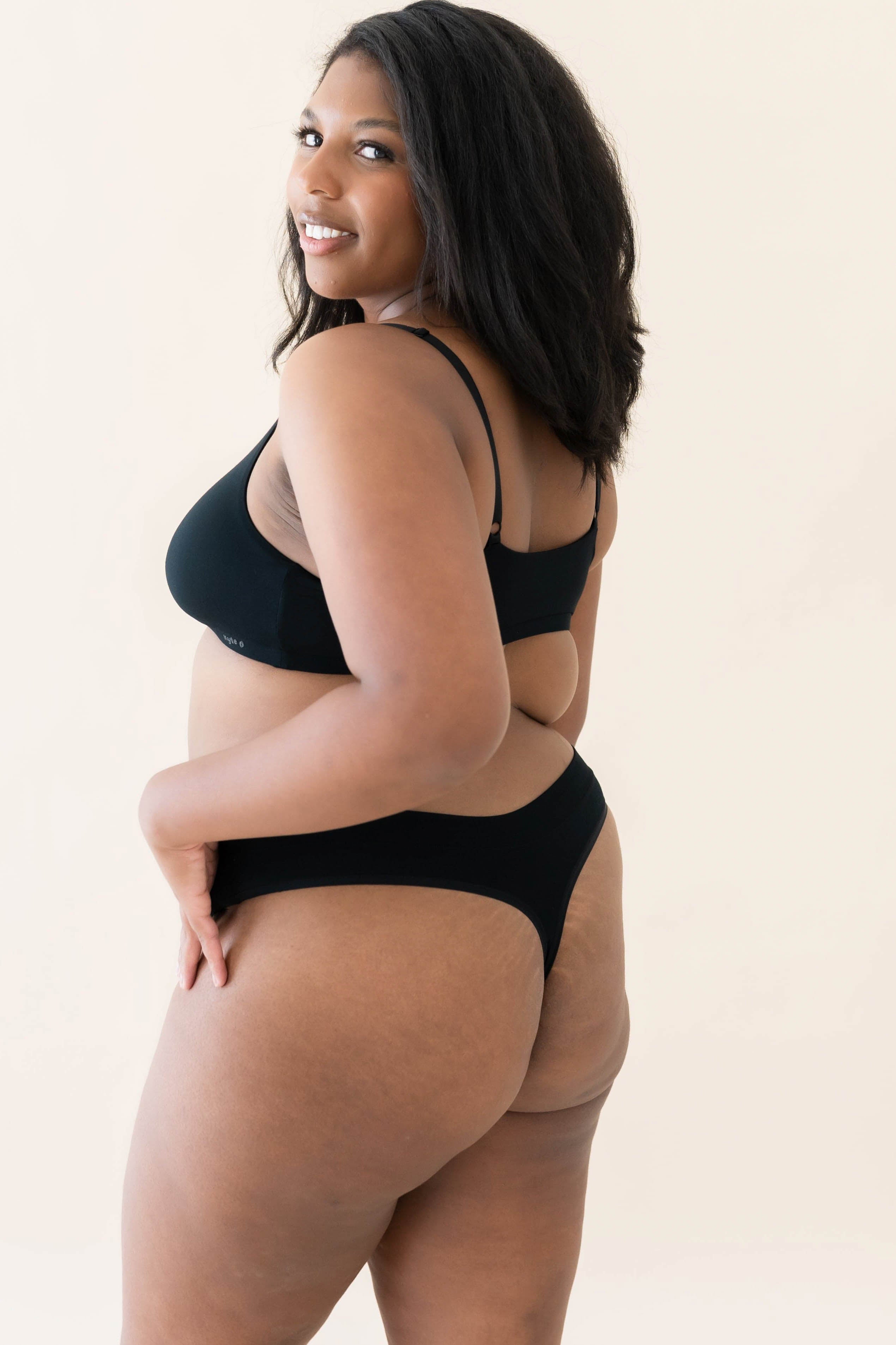 The back of the Kyte Baby's Women's Thong in Midnight on a model