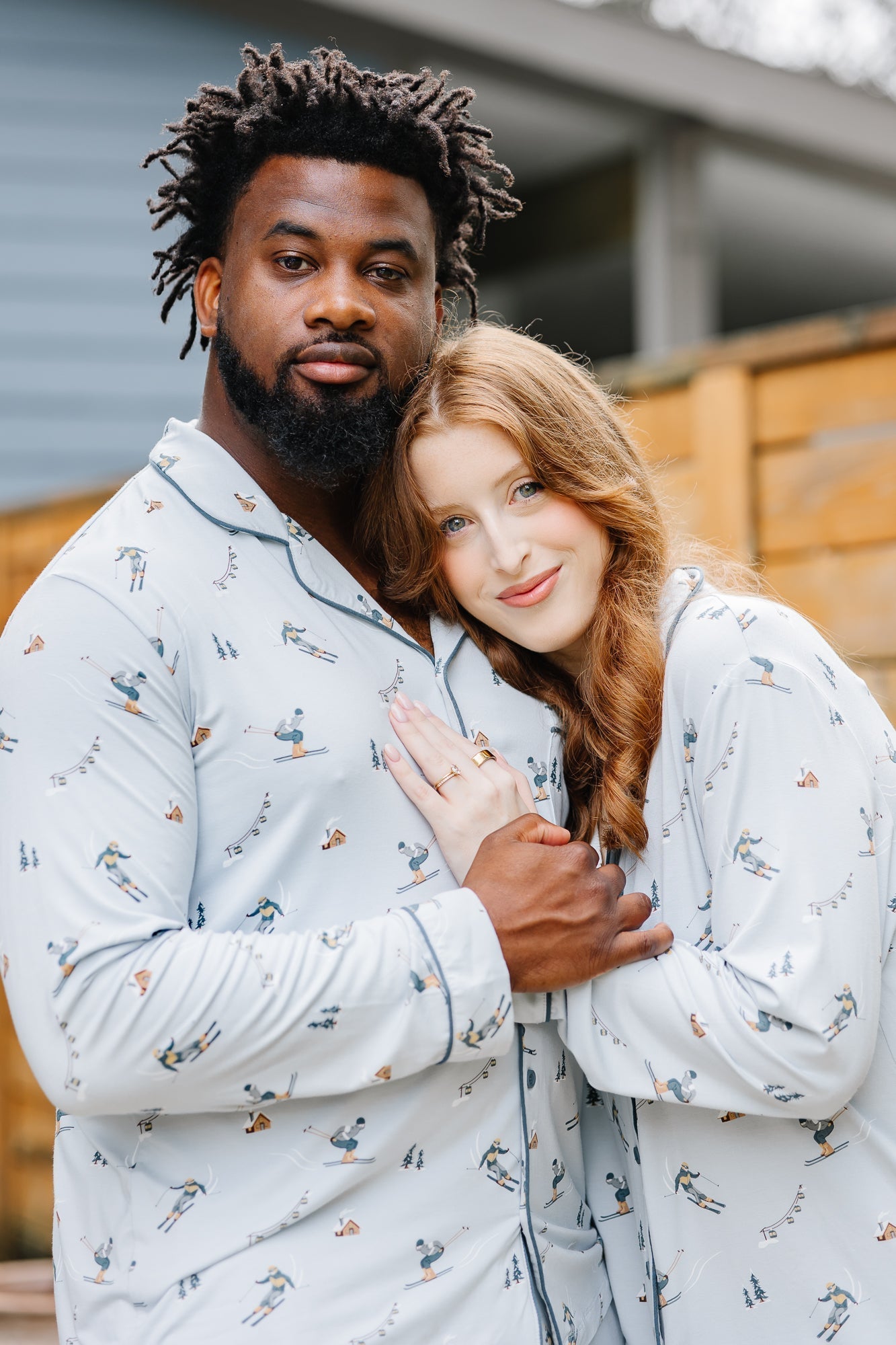 Couple snuggled in matching buttery soft bamboo button up pajama sets from Kyte Living