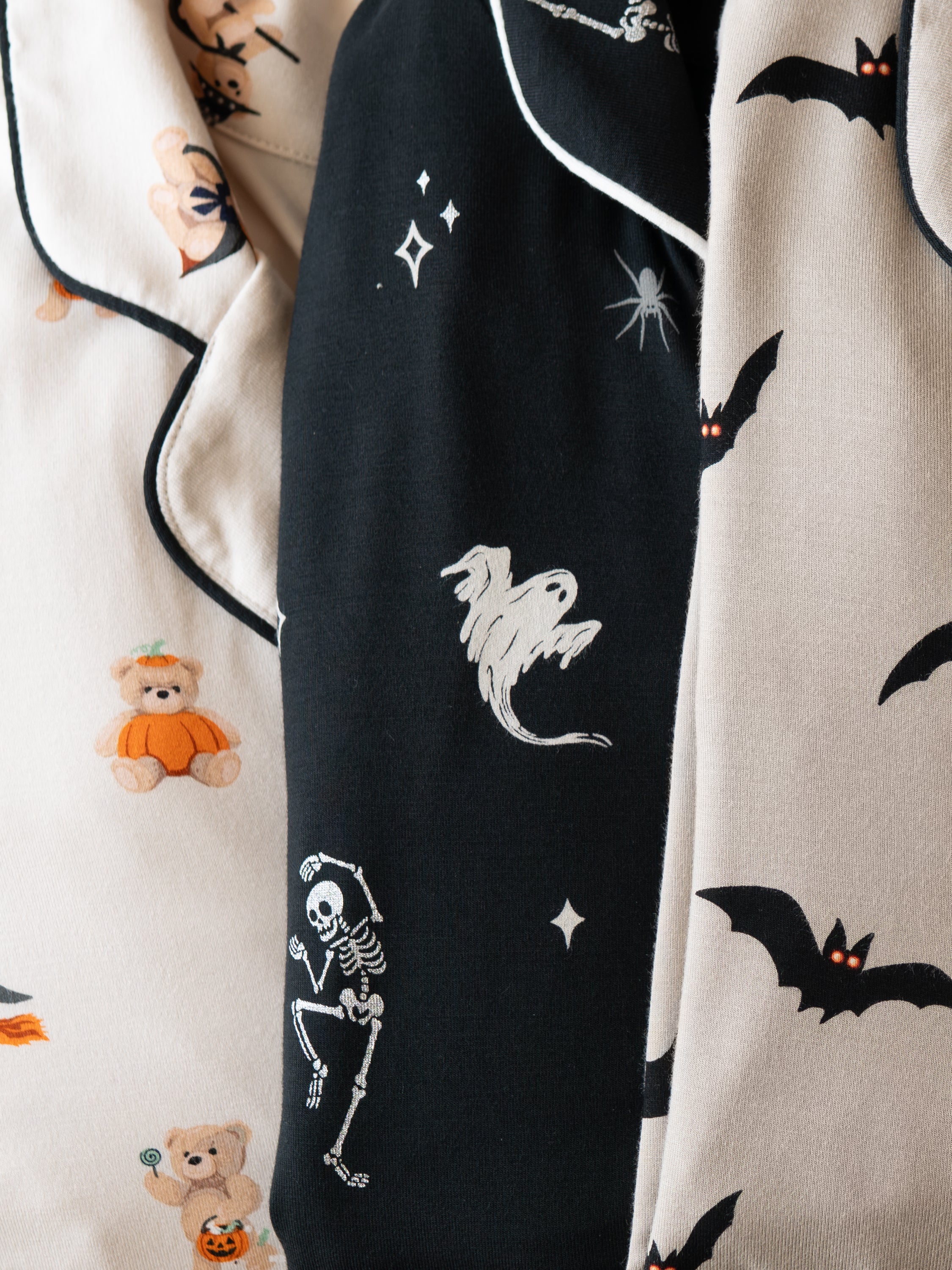 Modal wearing Long-Sleeved Women's Pajama Set in Bats print standing against a table