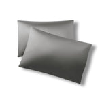 Two pillows one on top of the other with the Bamboo Sateen Pillowcases in Ash on them
