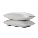Two pillows stacked one on top of the other with the Bamboo Sateen Pillowcase in Dove Gray on them