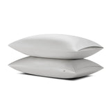 Two pillows stacked one on top of the other with the Bamboo Sateen Pillowcase in Dove Gray on them