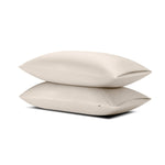 Two pillows stacked one on top of the other with the Bamboo Sateen Pillowcases in Sand Stone on them