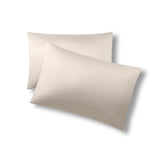 Two pillows one on top of the other with the Bamboo Sateen Pillowcases in Sand Stone on them