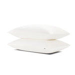 Two pillows stacked one on top of the other with the Bamboo Sateen Pillowcases in Shell on them