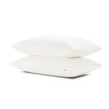 Two pillows stacked one on top of the other with the Bamboo Sateen Pillowcases in Shell on them
