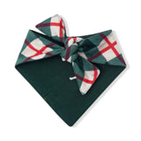 A dark green pet bandana featuring a plaid patterned tie in green, white, and red, displayed on a clean white background.