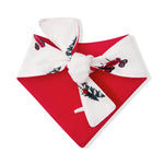 A red and white bandana-style pet bow tie featuring a printed pattern of red motorcycles, green holly leaves, and pine trees, shown on a plain white background.