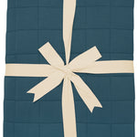 Quilted Blanket in Atlantic 2.5 TOG wrapped with an ivory bow