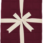 Product photo of the Bamboo Quilt Blanket in Burgundy 2.5 wrapped in an ivory bow