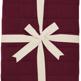 Product photo of the Bamboo Quilt Blanket in Burgundy 2.5 wrapped in an ivory bow