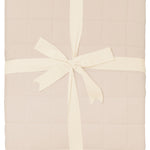 Product photo of the Bamboo Quilt Blanket in Bisque 2.5 wrapped in an ivory bow