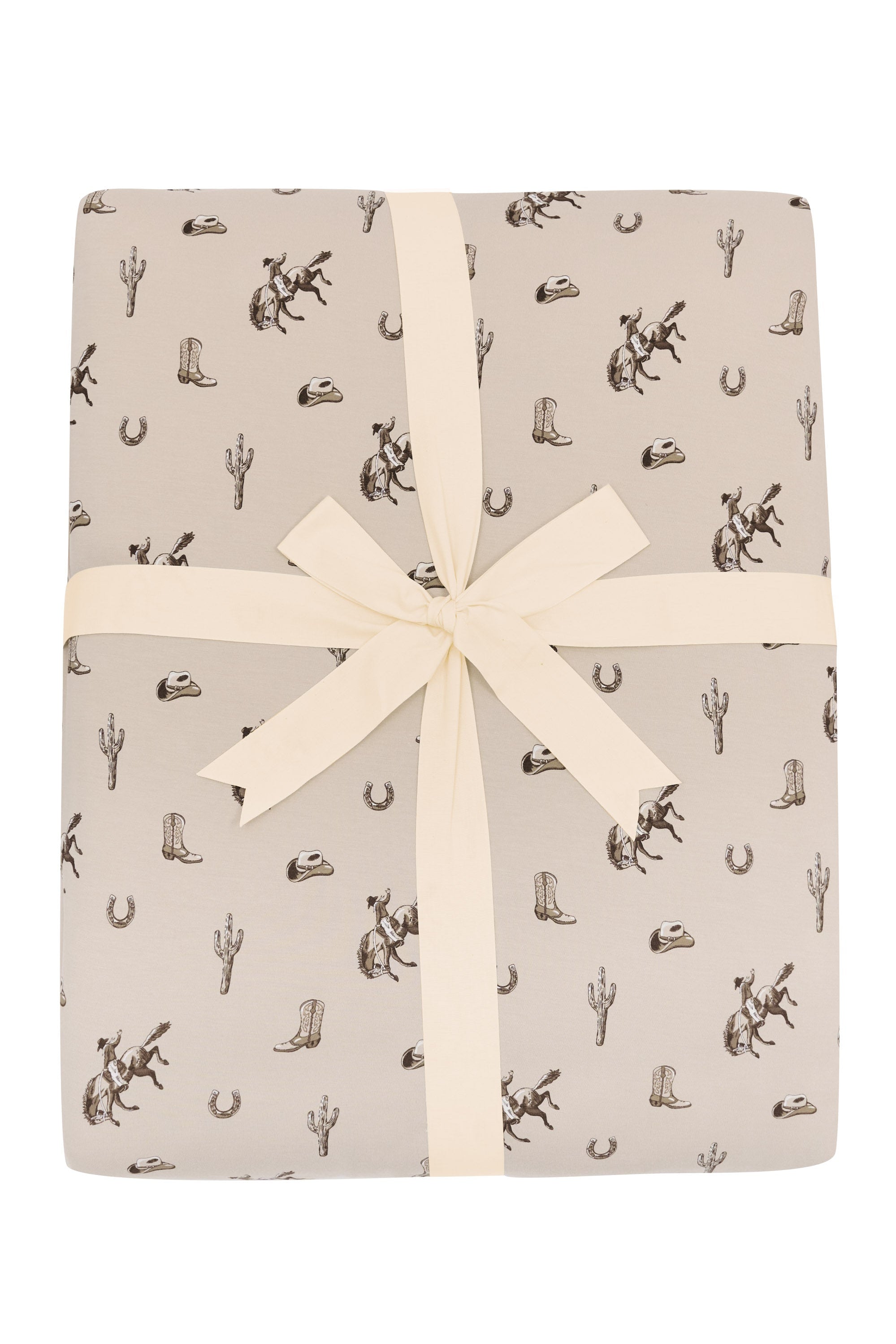 Product photo of the Adult Quilted Blanket in Classic Cowboy 2.5 shown tied in its packaging with a linen bow