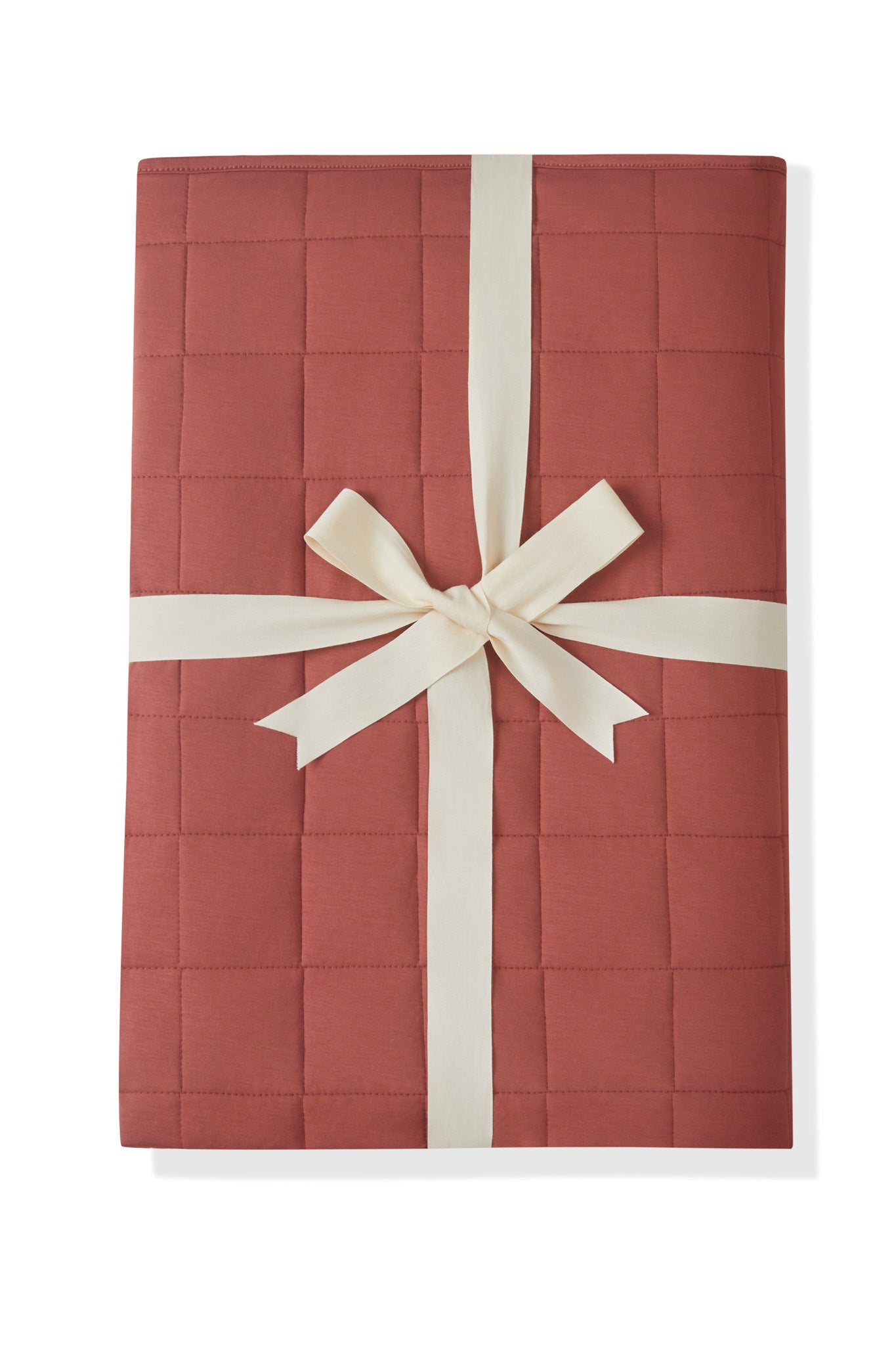 Adult Quilted Blanket in Ember 2.5 packed in a ribbon bow on a white background