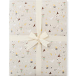 Folded Quilt Blanket in Starry Icon 2.5 on a white background with an ivory bow 