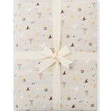 Folded Quilt Blanket in Starry Icon 2.5 on a white background with an ivory bow 