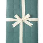 Adult Quilted Blanket in Pine 2.5 wrapped in a ribbon bow on a white background