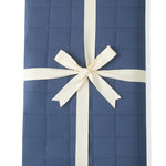 Adult Quilted Blanket in Oxford 2.5 wrapped in a ribbon bow on a white background