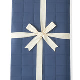 Adult Quilted Blanket in Oxford 2.5 wrapped in a ribbon bow on a white background
