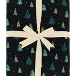 Product photo of the Kyte Bamboo Quilt Blanket in Twinkle Tree 2.5 wrapped in an ivory bow