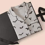 Long-Sleeved Women's Pajama Set in Bats packed in a box on a beige background
