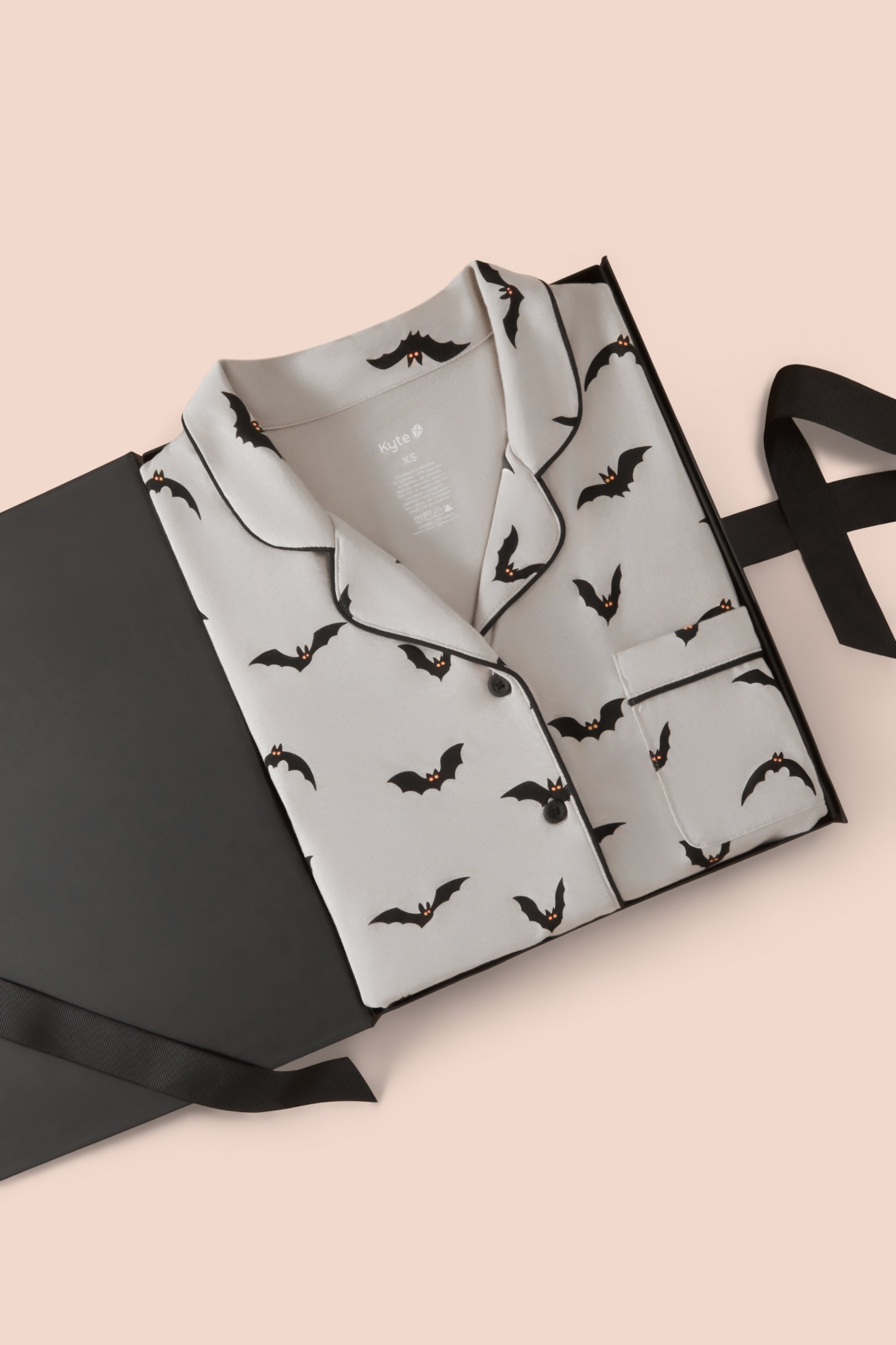 Long-Sleeved Women's Pajama Set in Bats packed in a box on a beige background