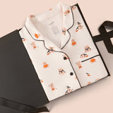 Long-Sleeved Women's Pajama Set in Halloween Teddy packed in a box on a beige background