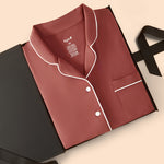 Long-Sleeved Women's Pajama Set in Ember packed on a beige background