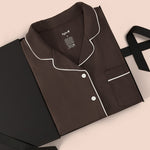 Long-Sleeved Women's Pajama Set in Espresso with Cloud Trim packed in a box on a beige background