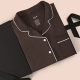 Long-Sleeved Women's Pajama Set in Espresso with Cloud Trim packed in a box on a beige background