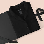 Long-Sleeved Women's Pajama Set in Midnight packed in a box on a beige background