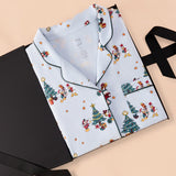 Long-Sleeved Women's Pajama Set in Mickey & Friends Christmas print packed in a black box on a beige background