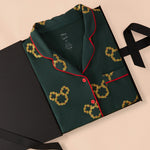 Long-Sleeved Women's Pajama Set in Mickey Christmas Wreath print packed in a black box on a beige background