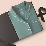 Long-Sleeved Women's Pajama Set in Pine packed on a beige background