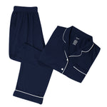 Navy pajama set with white piping on a white backdrop