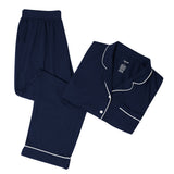 Navy pajama set with white piping on a white backdrop