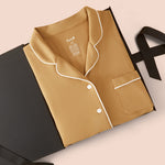 Long-Sleeved Women's Pajama Set in Ochre packed on a beige background